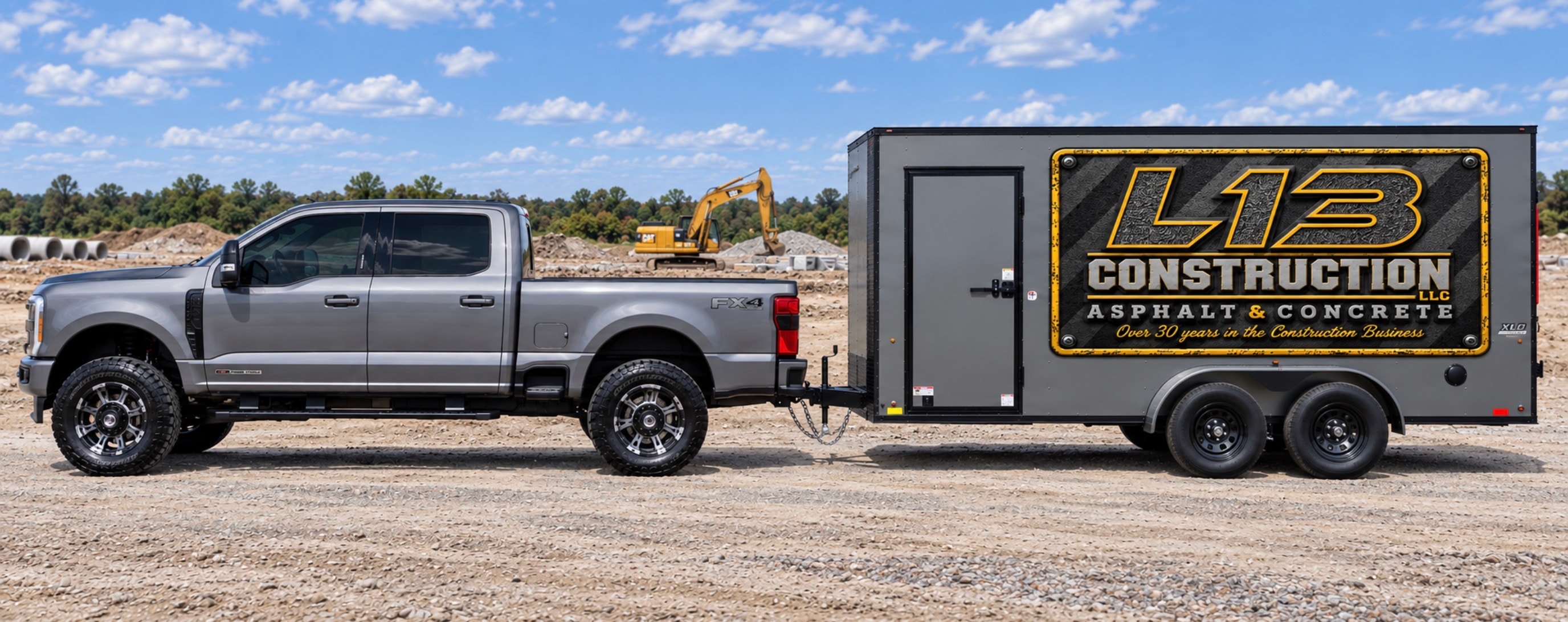 L13 Construction branded truck and trailer on job site